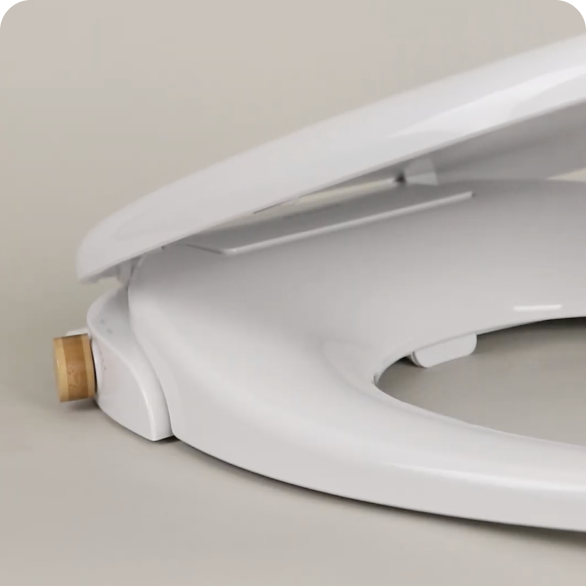 Close up of the bidet toilet seat profile with cover, on a Tushy WAVE