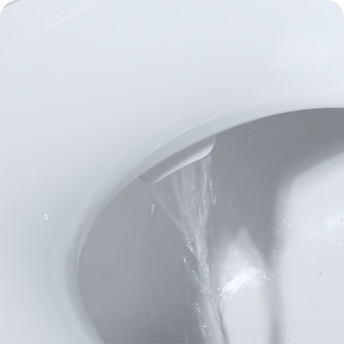 Extreme close up of water shoot down into the toilet from a Tushy Wave attachment