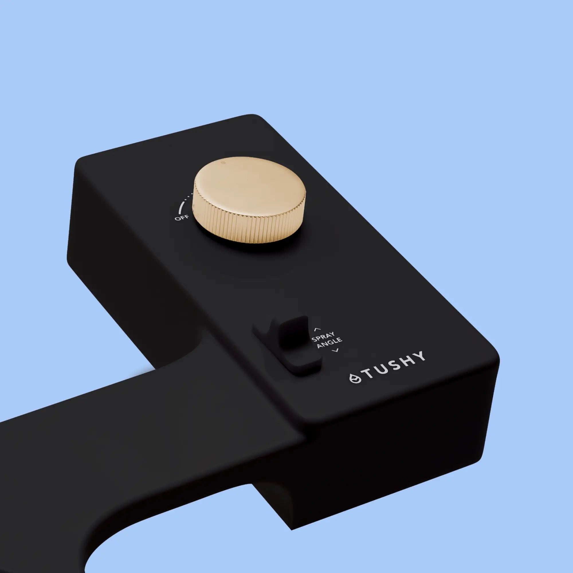 Black 'TUSHY' Classic console, with a gold pressure control knob, on a light blue background