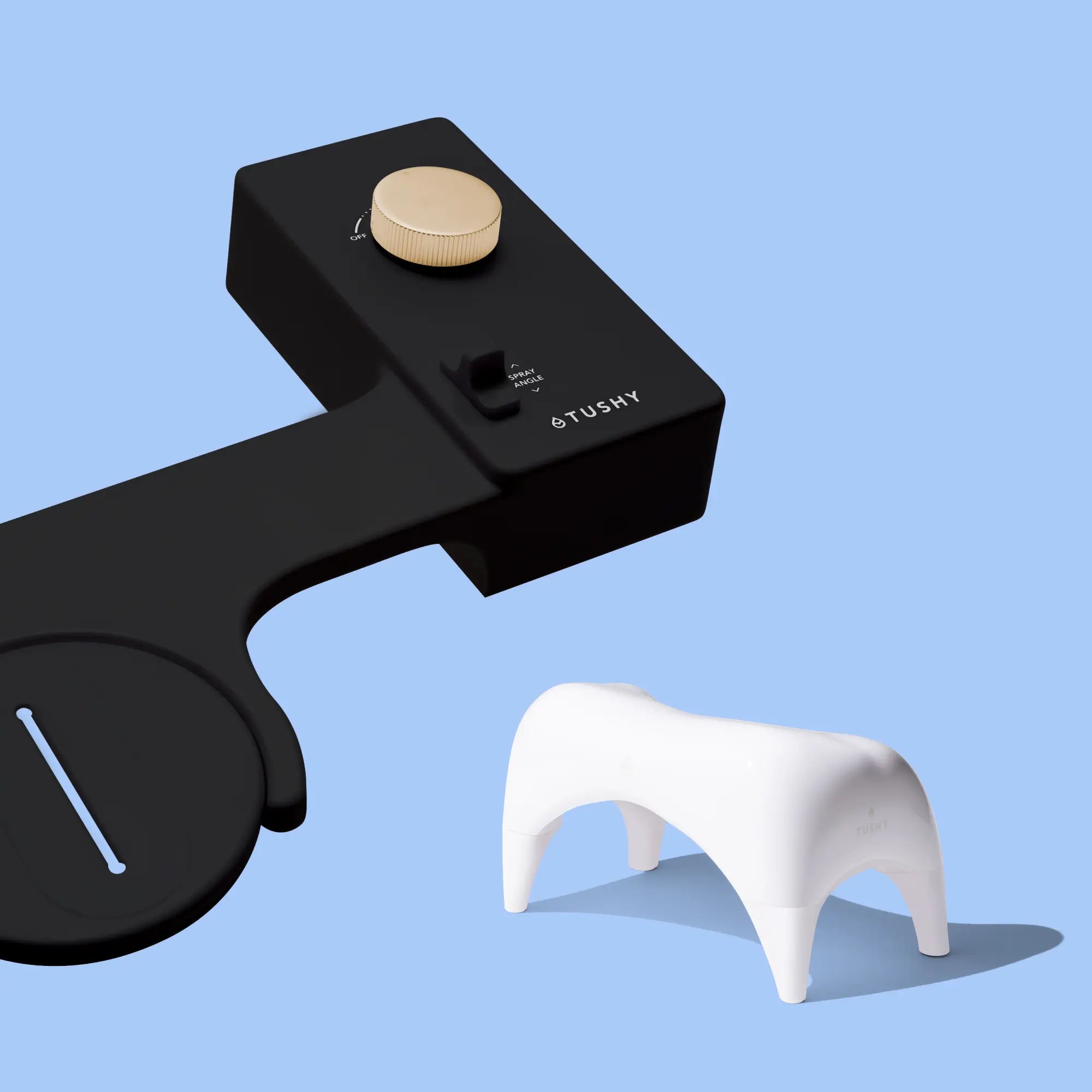 Black 'TUSHY' Classic console, with a gold pressure control knob, and a white Tushy Ottoman, on a light blue background