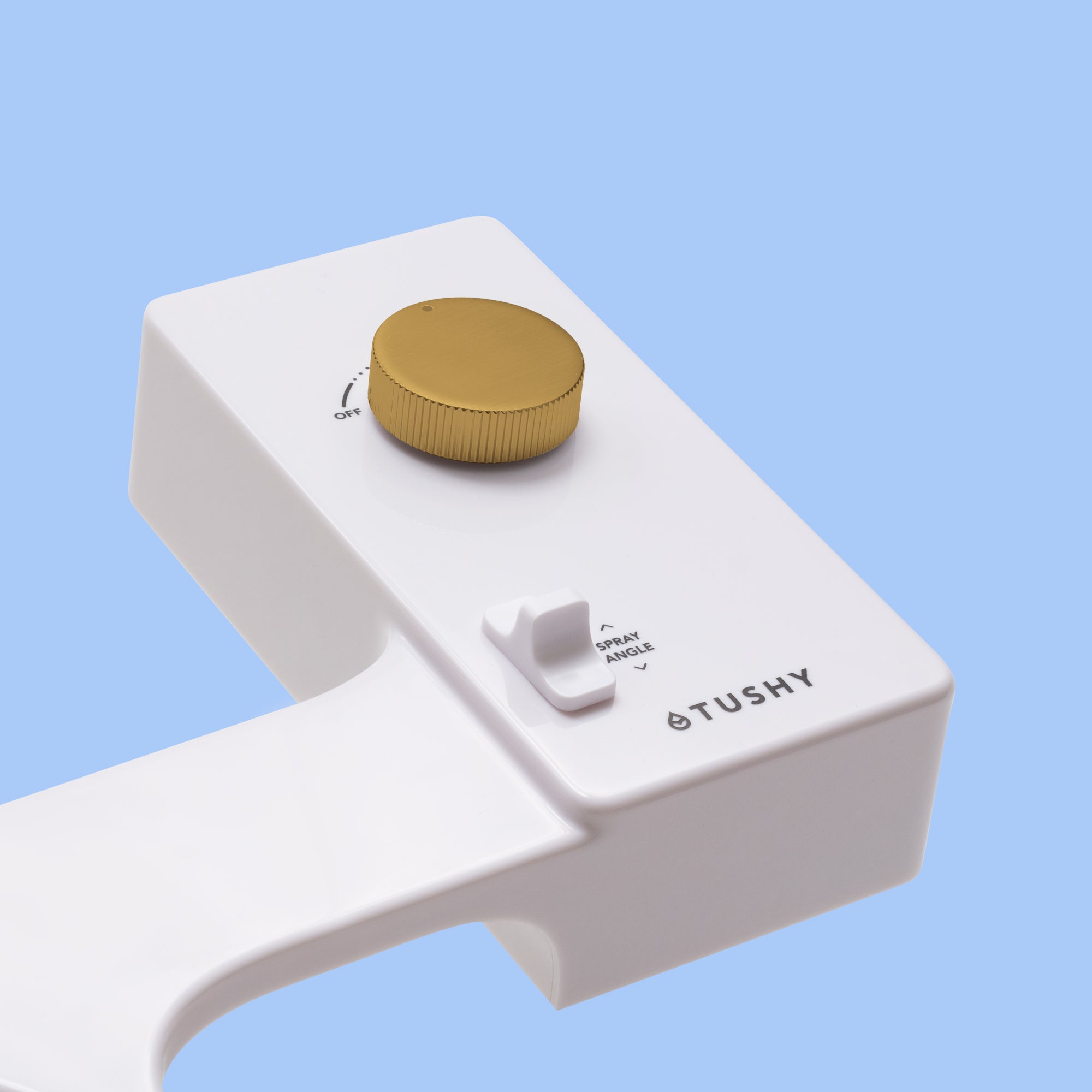 White bidet attachment with a gold control knob and a spray angle adjustment lever.