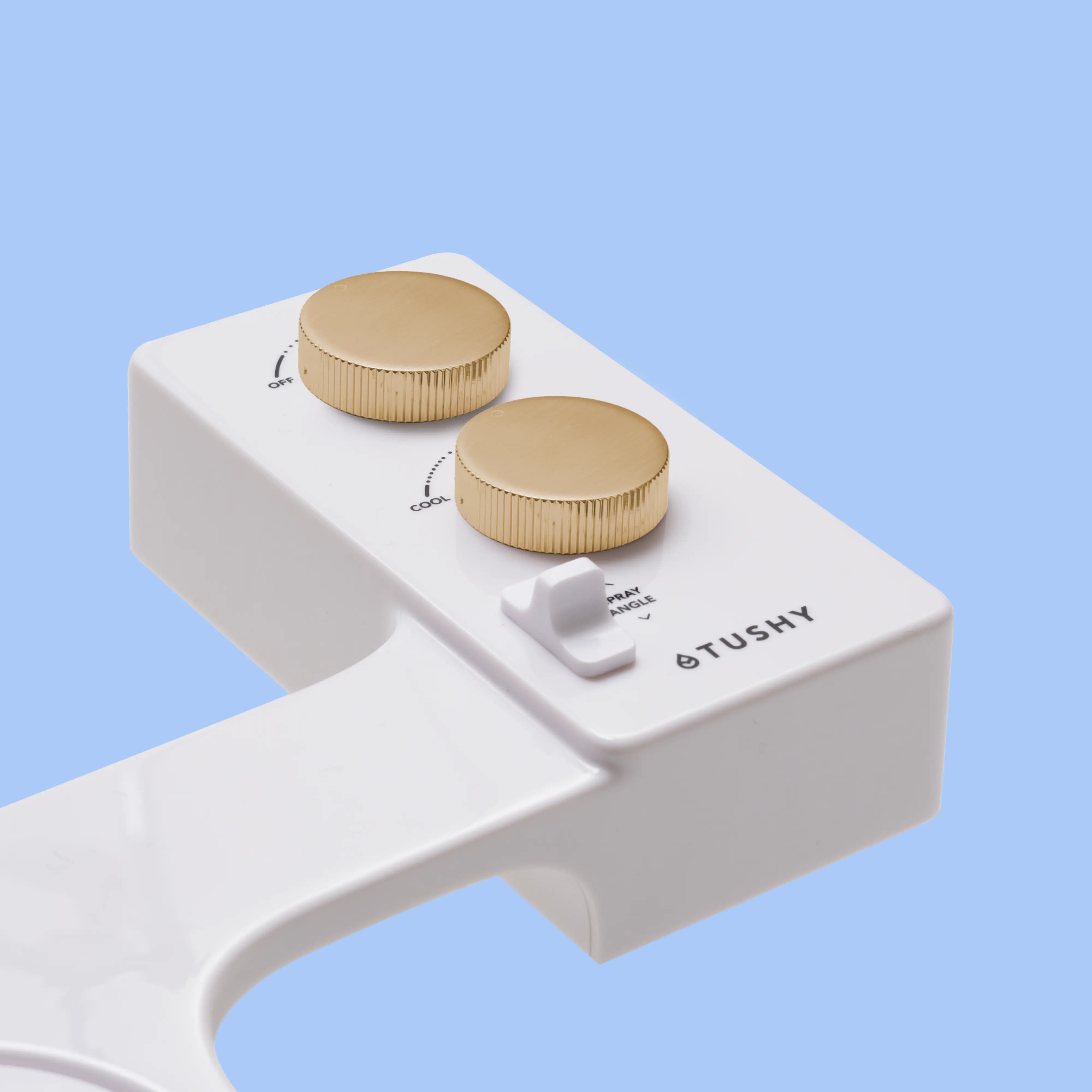 White TUSHY Spa console with 2 gold knobs, on a blue background