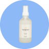 Small blue circle with Tushy room spray bottle