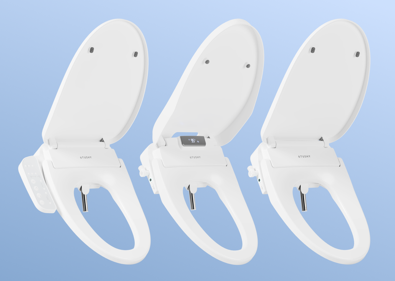 Three white toilet seat bidets on a light blue background