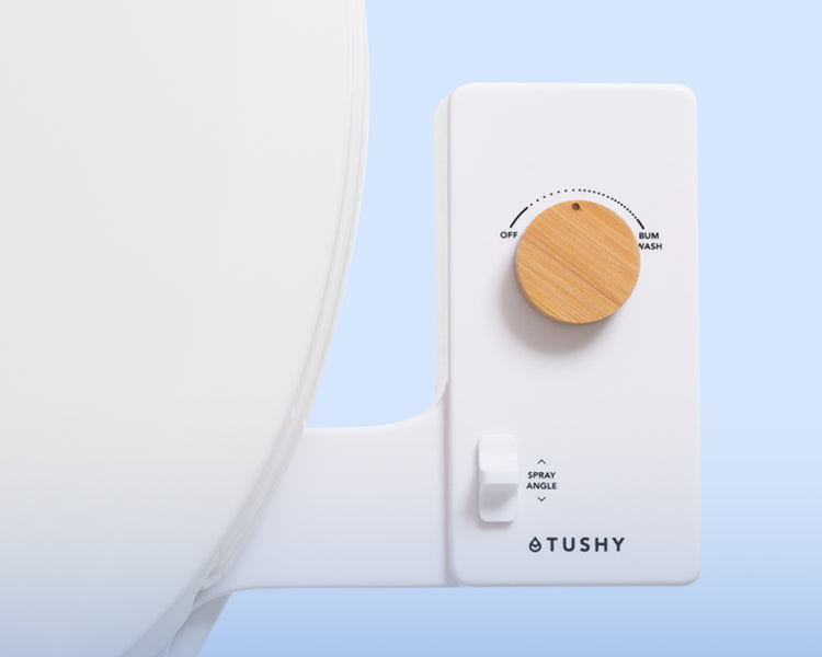 Close up of a TUSHY Classic pressure control knob in bamboo