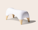 TUSHY Ottoman on a light beige background
