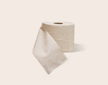 Roll of TUSHY bamboo toilet paper on a light beige background