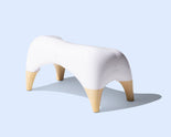 TUSHY Ottoman on a light blue background
