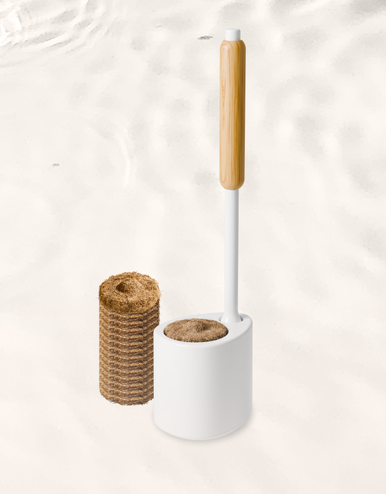 White toilet brush with bambpp handle and brown coconut husk cleaning pads, on a light beige background
