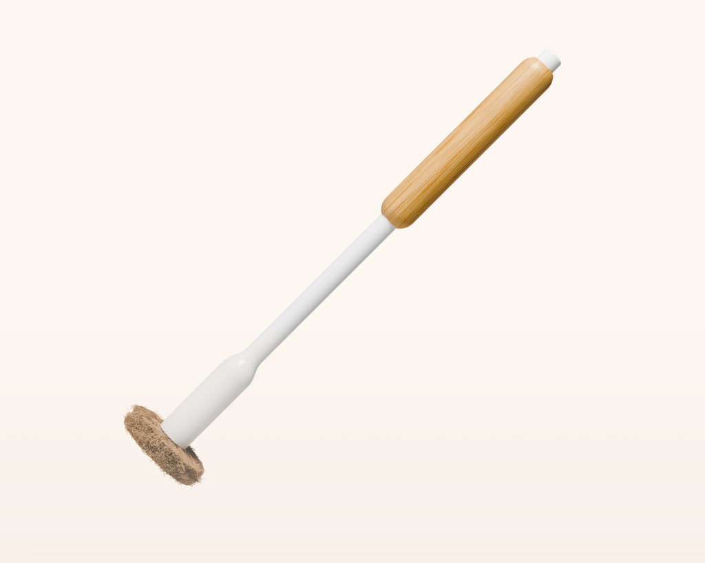 Tushy Toilet brush with bamboo handle and coconut husk scrubbing pad, on a white background