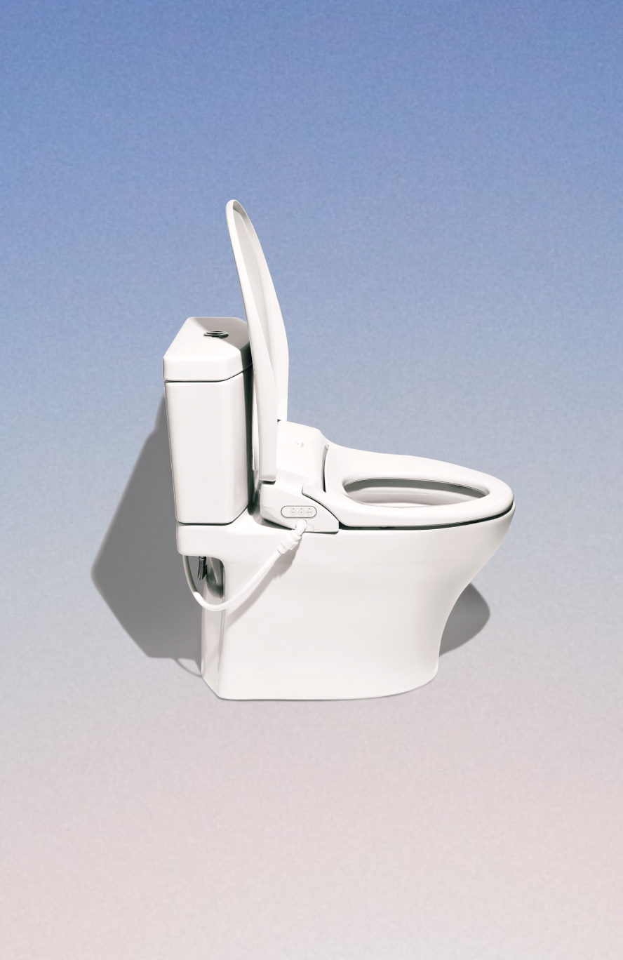 White bidet-style toilet with attached control panel on a gradient background.