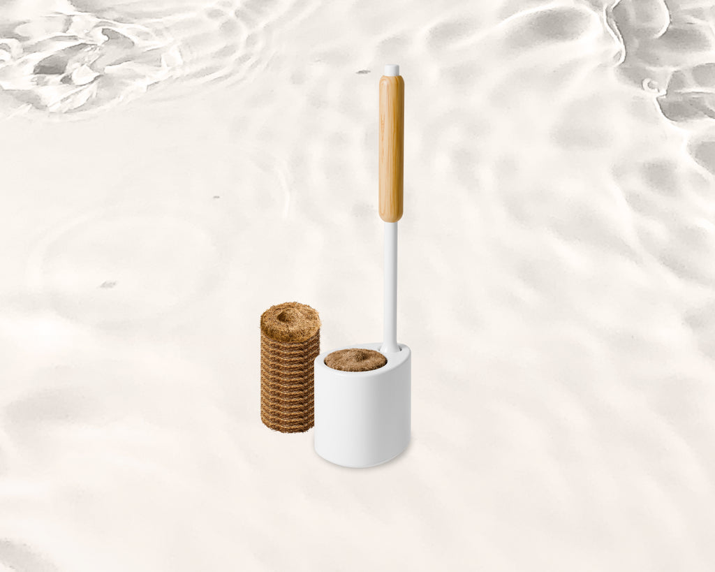 Tushy toilet Cleaning brush with a bamboo handle and coconut husk scrubbing pads, on a white background