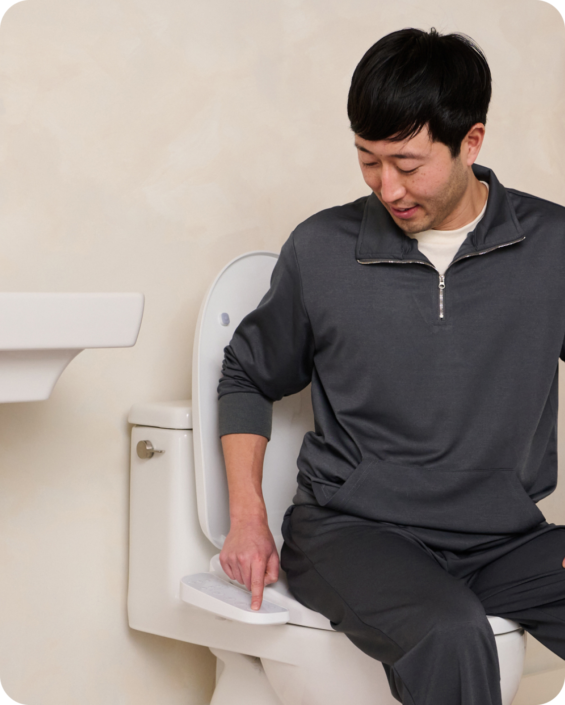 A man using the Cloud by TUSHY bidet seat