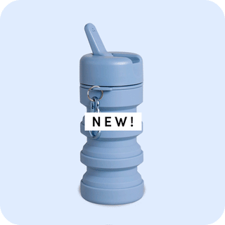 Collapsible blue travel bottle with a lid and keychain attachment.