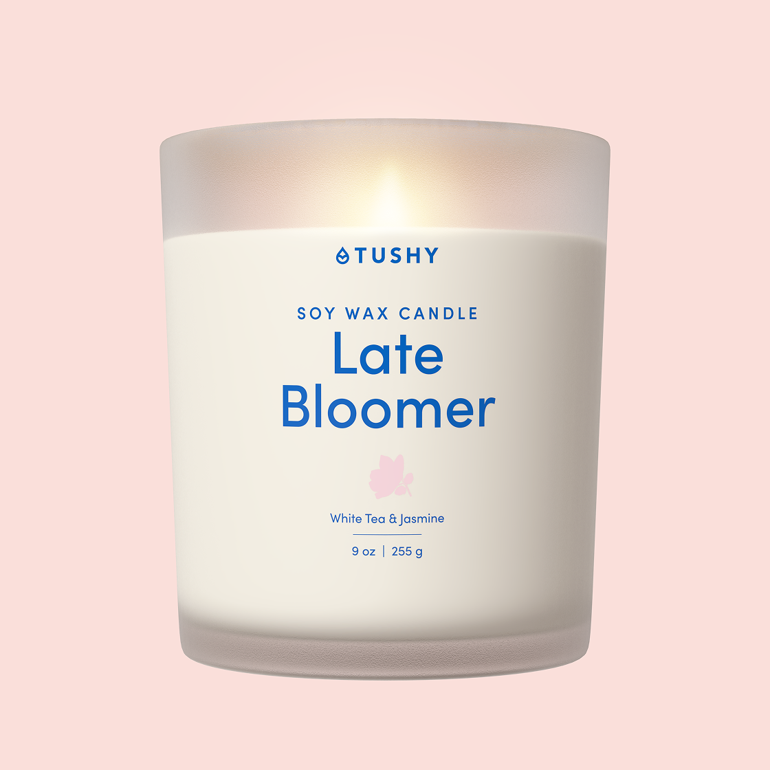 TUSHY 'Late Bloomer' soy wax candle on a pink background