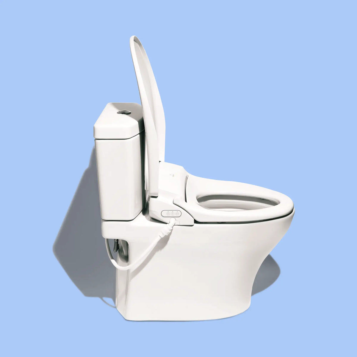 Side view of a white toilet with a TUSHY Ace bidet seat