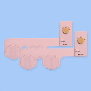 2 pack of TUSHY Classics in pink, with bamboo pressure control knobs, on a light blue background