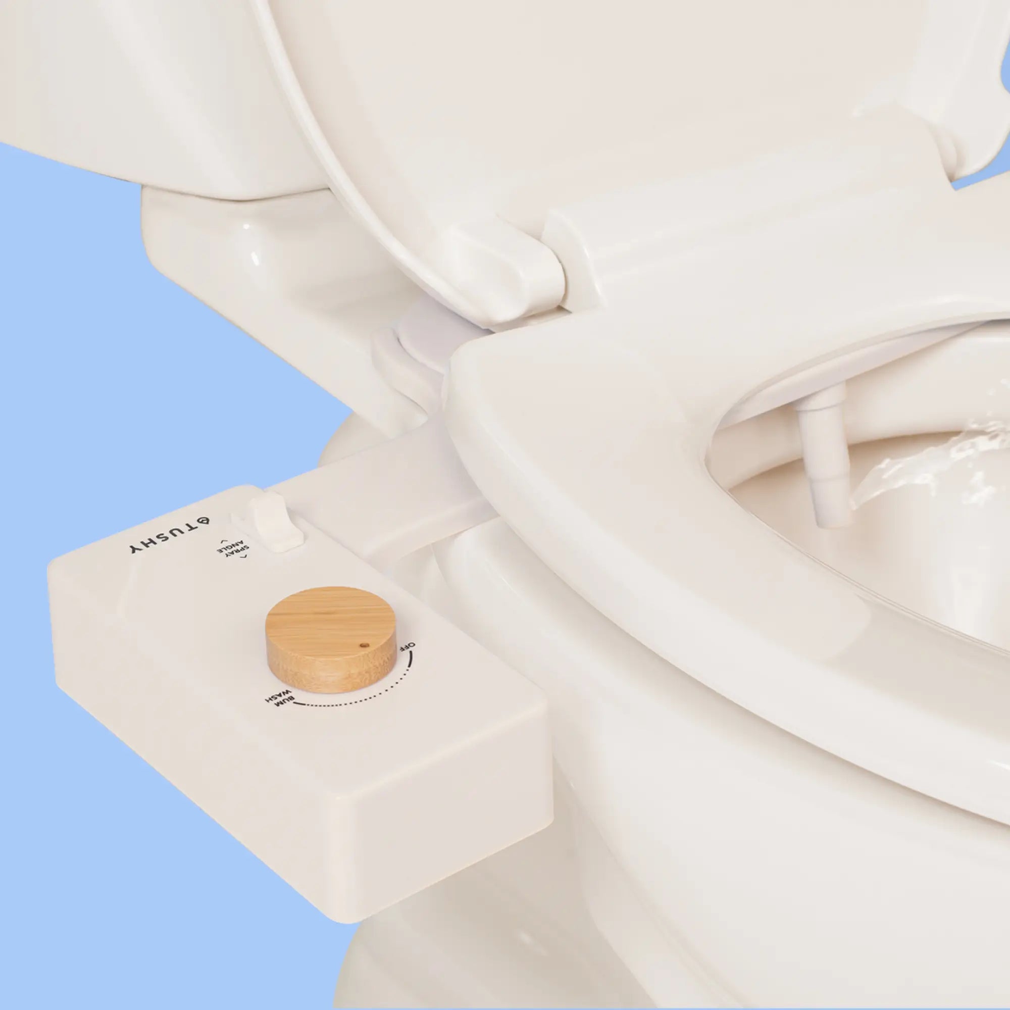 Biscuit 'TUSHY' Classic console, with a bamboo pressure control knob, installed on a toilet, on a light blue background