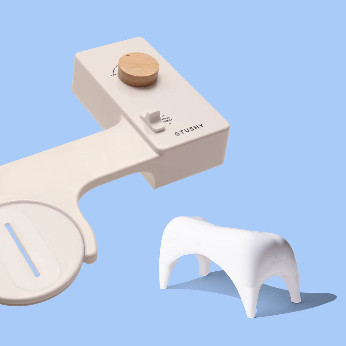 Biscuit 'TUSHY' Classic console, with a bamboo pressure control knob, and a white Tushy Ottoman, on a light blue background