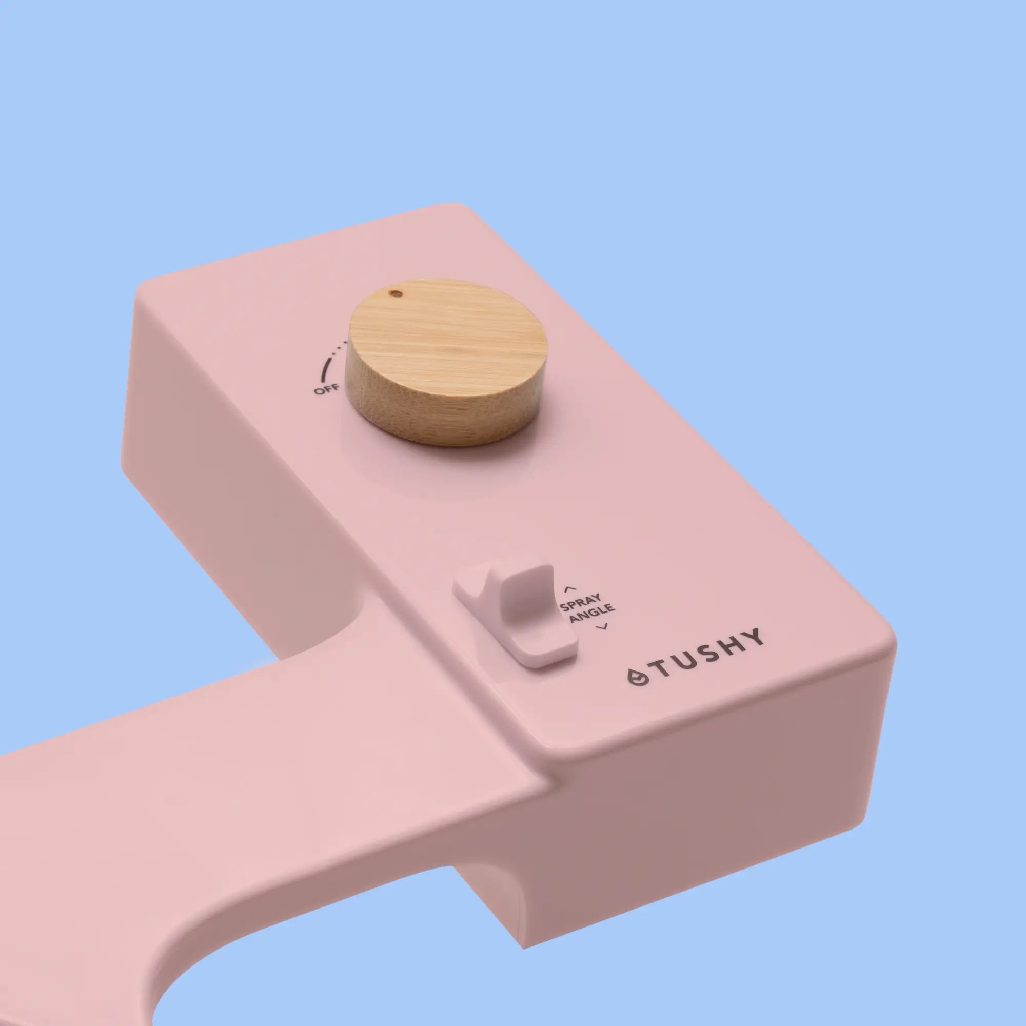 Pink 'TUSHY' Classic console, with a bamboo pressure control knob, on a light blue background