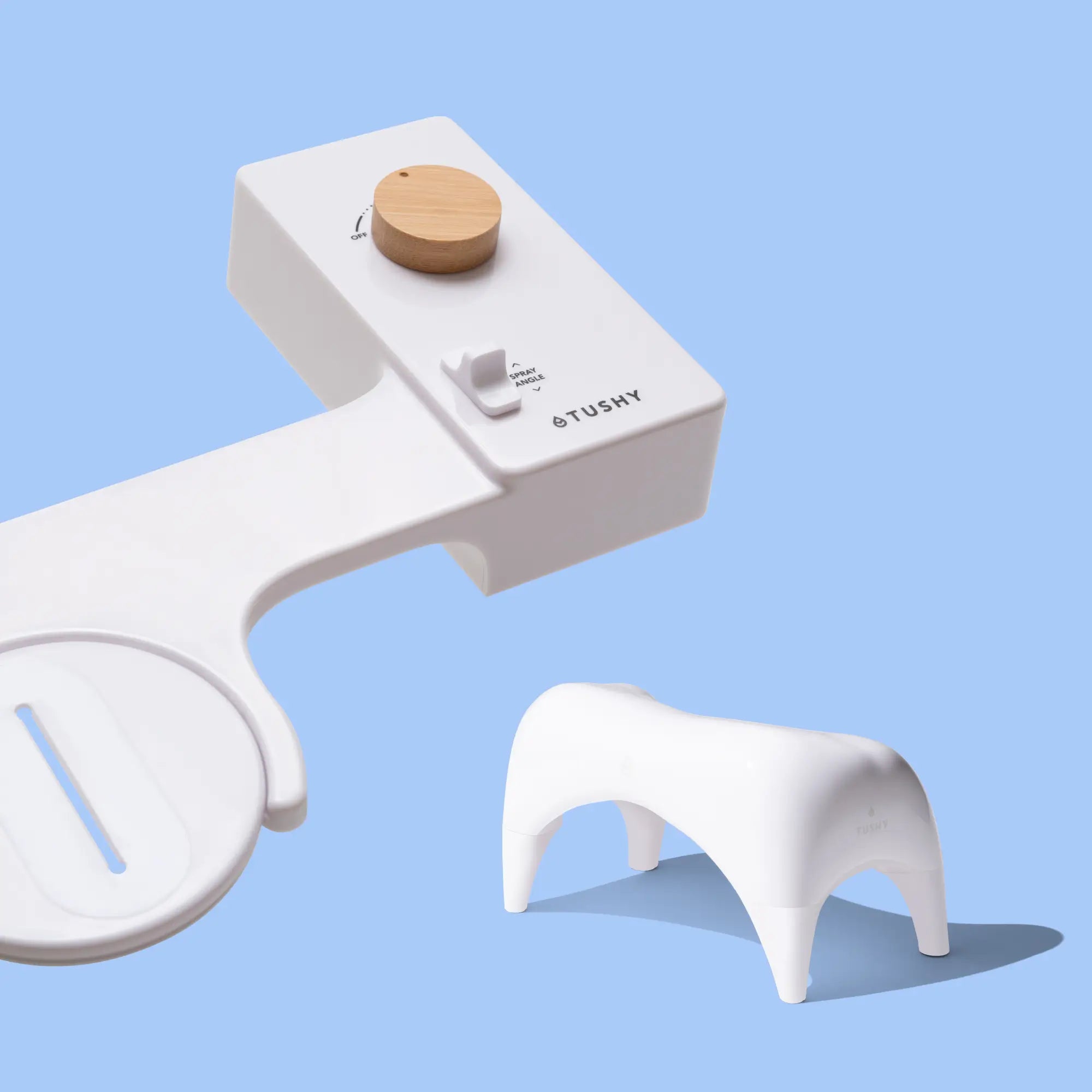 White 'TUSHY' Classic console, with a bamboo pressure control knob, and a white Tushy Ottoman, on a light blue background