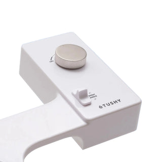 White 'TUSHY' Classic console, with a platinum pressure control knob, on a light blue background