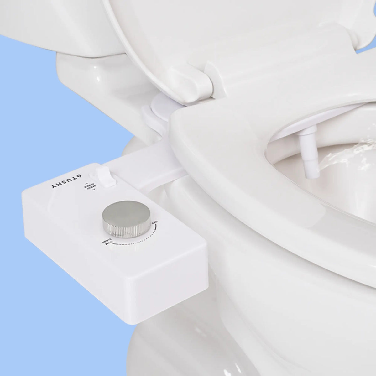 White 'TUSHY' Classic console, with a platinum pressure control knob, installed on a toilet, on a light blue background