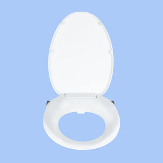Front view White TUSHY Oasis bidet seat, with platinum control knobs, on a blue background