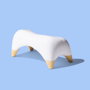 White and bamboo TUSHY ottoman stool on a light blue background