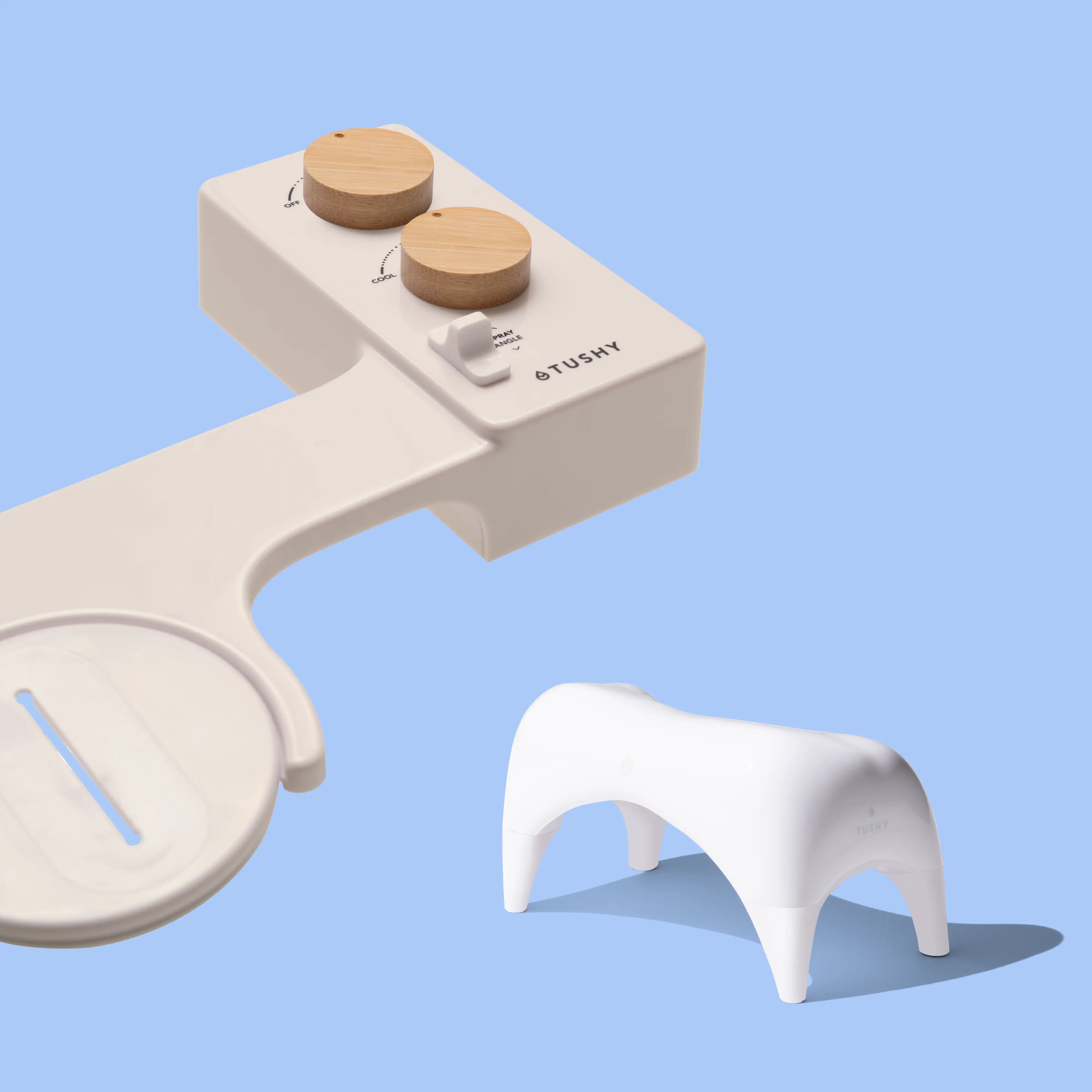 Biscuit TUSHY Spa console with 2 bamboo knobs, and a white ottoman, on a blue background