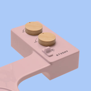 Pink TUSHY Spa console with 2 bamboo knobs, on a blue background