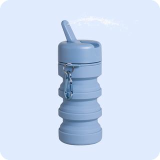 Light blue travel bidet with water spraying out