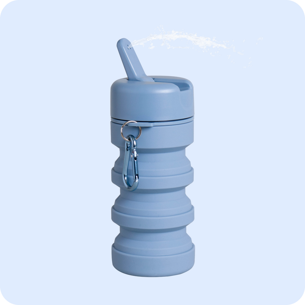 Light blue travel bidet with water spraying out