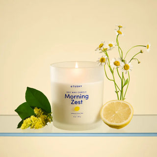 Candle labeled 'Morning Zest' with lemon and flower elements on a light background
