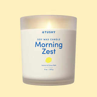 TUSHY Morning Zest candle on a light yellow background