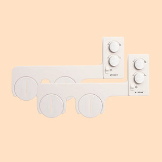 White bidet attachment with two control panels and circular spray nozzles for adjustable water pressure and temperature.