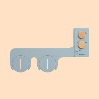 Bidet attachment with two circular nozzles and a control panel featuring three knobs in a light blue color.