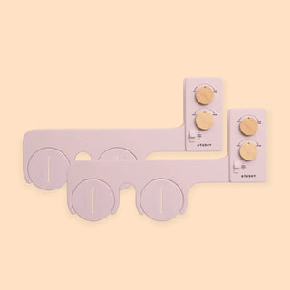 Bidet attachment with two control panels and adjustable knobs for water pressure and temperature, in a light color.
