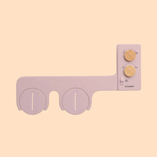 Bidet attachment with two circular nozzles and control panel featuring three knobs for adjusting settings.