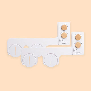 White bidet attachment with wooden knobs for water pressure and temperature control, featuring two circular controls.