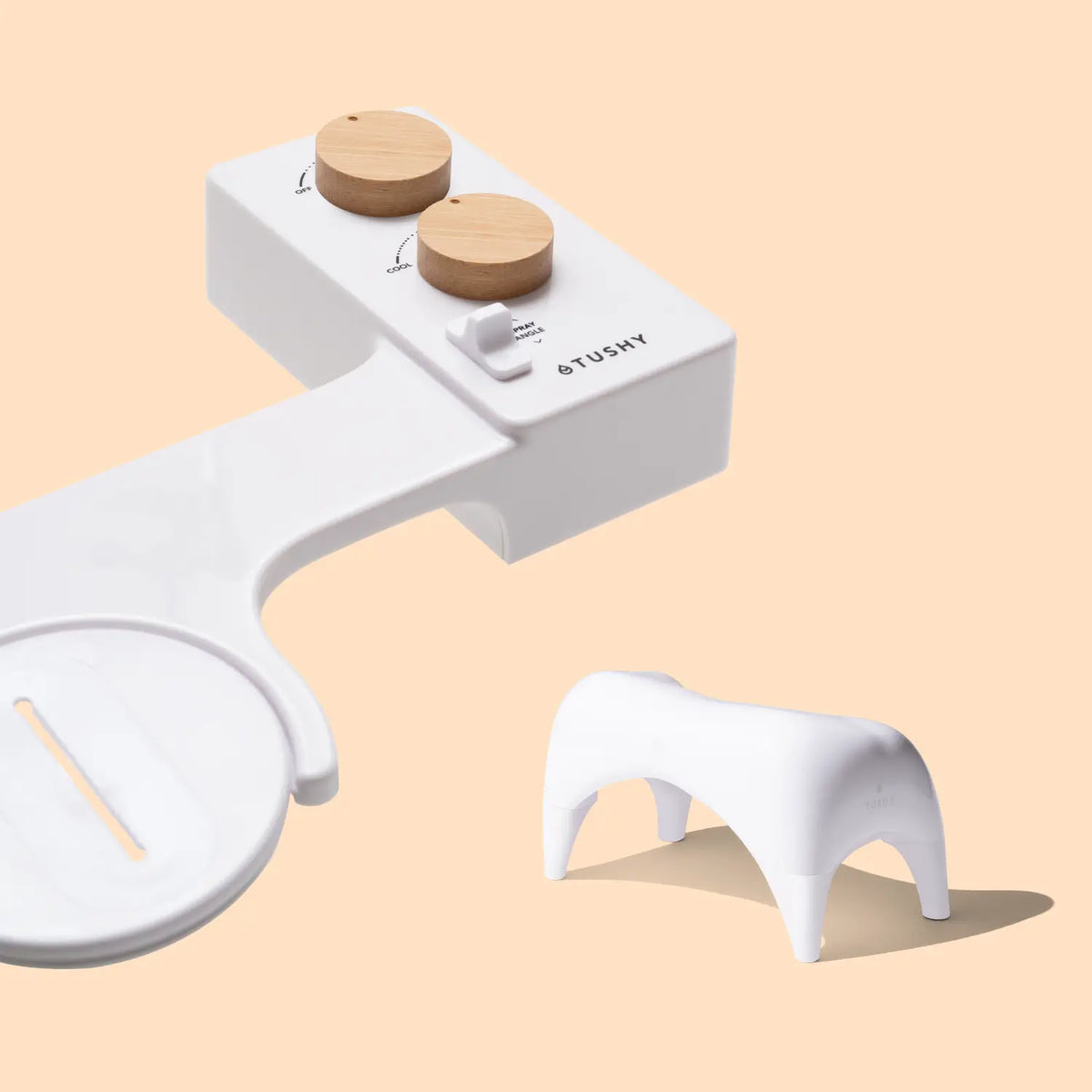 White bidet attachment with wooden knobs and a small white stool.