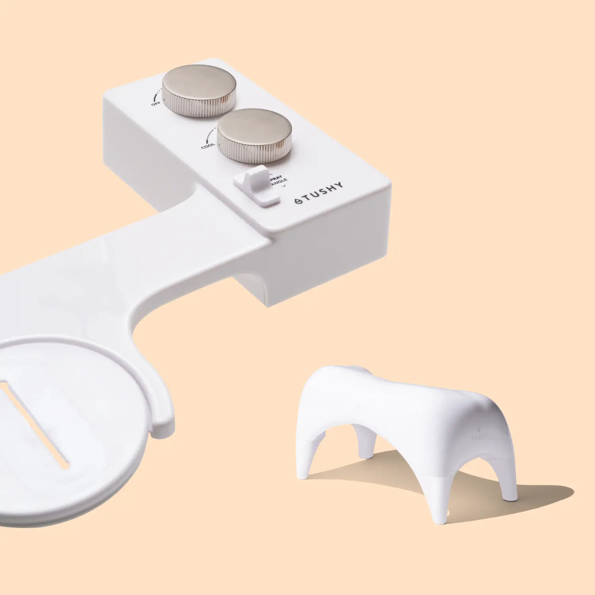 White bidet attachment with two control knobs and a small white stool.