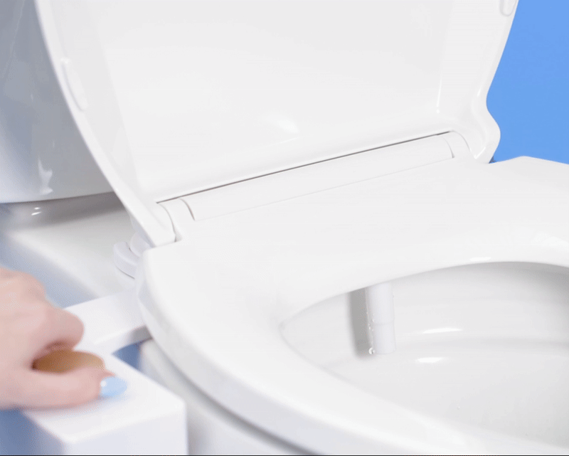 Gif of a woman turning a tushy classic and water spraying from the nozzle