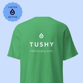 Green t-shirt with 'TUSHY' logo and website on a light blue background