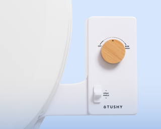 Close up of a TUSHY Classic pressure control knob in bamboo